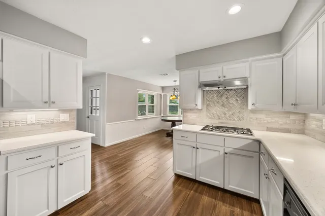 a kitchen with cabinets a sink and appliances