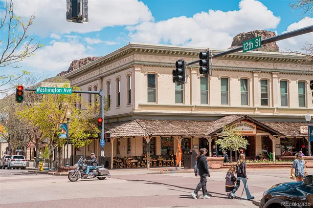 front view of a house with a small yard and potted plants