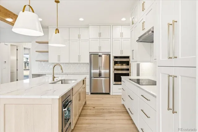 a kitchen with white cabinets and stainless steel appliances