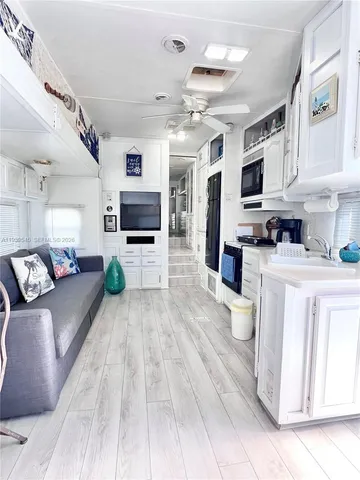 a large white kitchen with cabinets