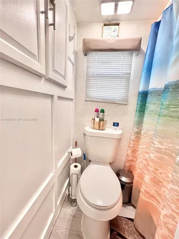 a white toilet sitting next to a bathroom sink
