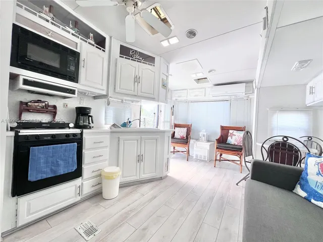 a kitchen with stainless steel appliances a stove a microwave and cabinets