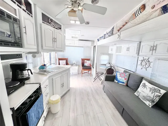 a open kitchen with stainless steel appliances granite countertop a stove and cabinets