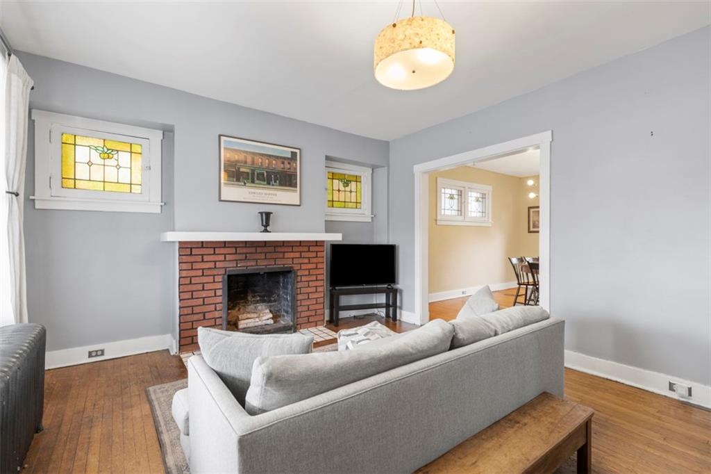 1141 Chislett Street Pittsburgh, PA 15206 - Photo 4 of 34 a living room with furniture and a fireplace