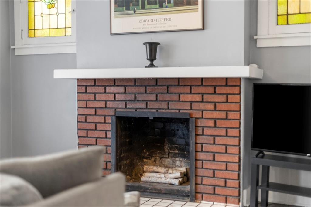 1141 Chislett Street Pittsburgh, PA 15206 - Photo 5 of 34 a room with a fireplace and a table