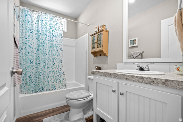 150 West 7500th South, Unit 13 Midvale, UT 84047 - Photo 22 of 32 Bathroom featuring a white vanity with beadboard paneling, stone-finish countertop, and undermount sink