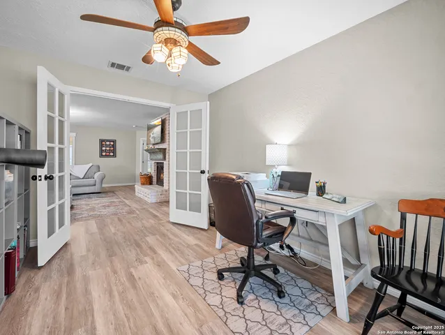 a view of a workspace with furniture and a chandelier