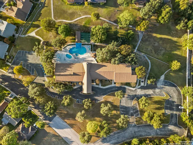 an aerial view of residential houses with outdoor space