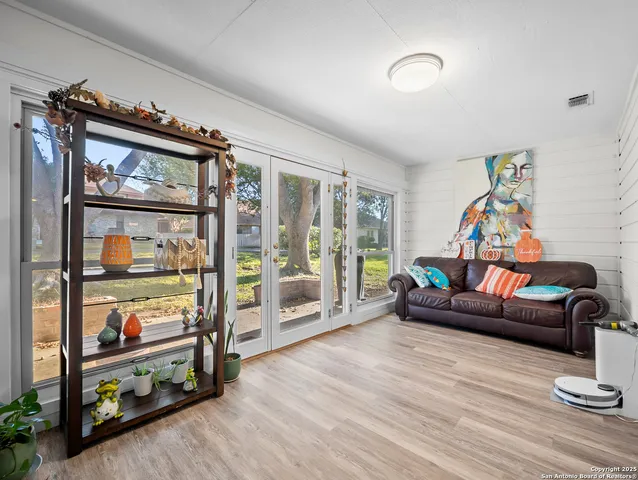 a living room with furniture and a floor to ceiling window