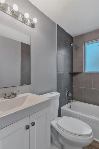 a bathroom with a sink a toilet and bathtub