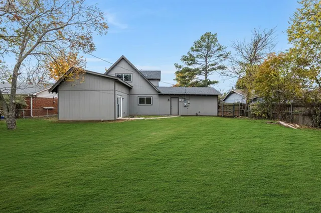 a front view of house with a garden