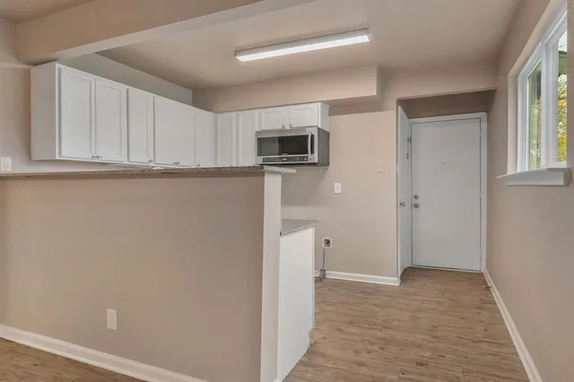 a view of a kitchen with refrigerator and microwave