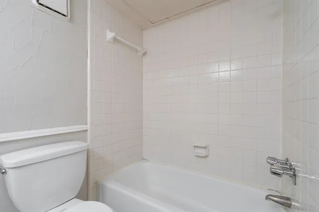 a bathroom with a bathtub and a toilet