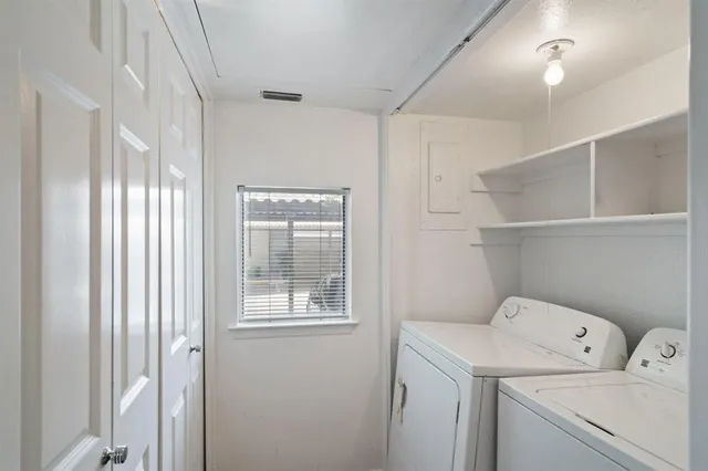 a view of storage and utility room with washer and dryer