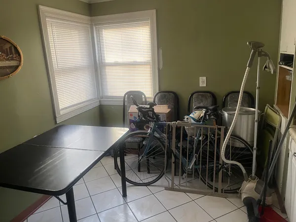 a dining room with furniture and a window
