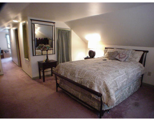 2146 Wilbraham Road Springfield, MA 01129 - Photo 6 of 8 a spacious bedroom with a bed and a dresser in it