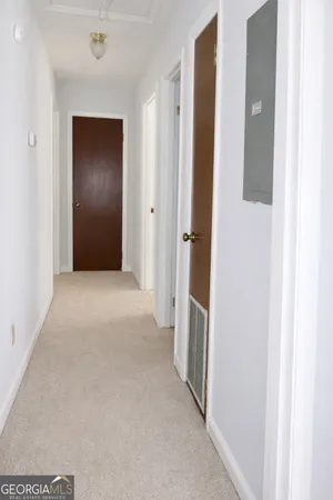 a view of hallway with wooden floor