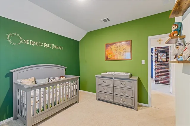 a bedroom with a bed and a baby crib