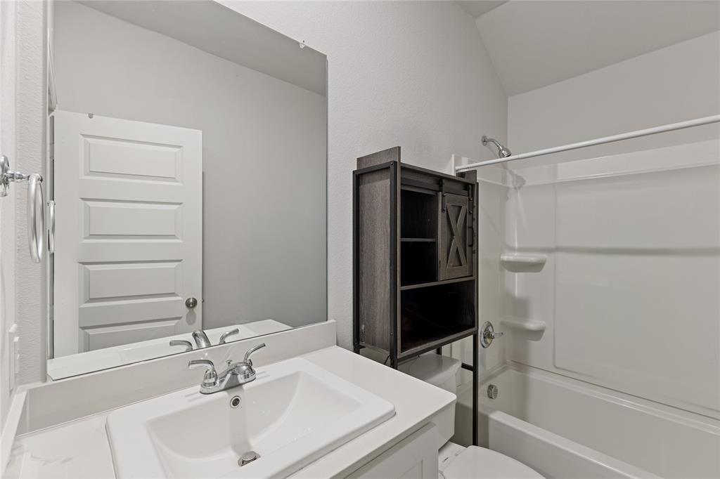 2404 Atlantic Avenue Anna, TX 75409 - Photo 17 of 26 a bathroom with a sink toilet and shower