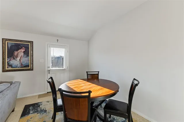 a view of a dining room with furniture and a window