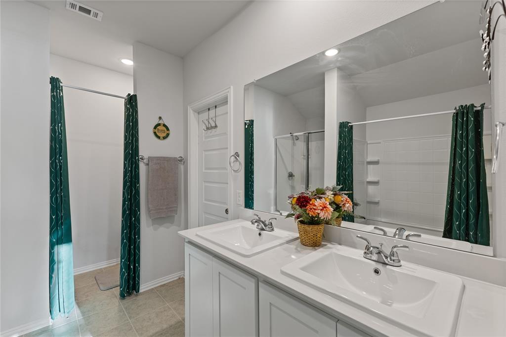 2404 Atlantic Avenue Anna, TX 75409 - Photo 21 of 26 a bathroom with a sink and a mirror