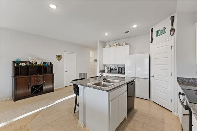 a kitchen with a sink stove and refrigerator