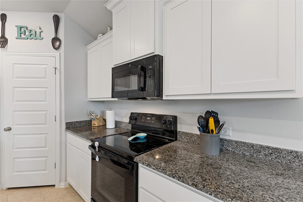 2404 Atlantic Avenue Anna, TX 75409 - Photo 8 of 26 a kitchen with a sink stove and cabinets