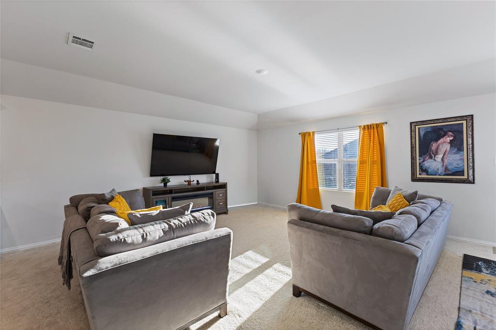 2404 Atlantic Avenue Anna, TX 75409 - Photo 9 of 26 a living room with furniture and a flat screen tv