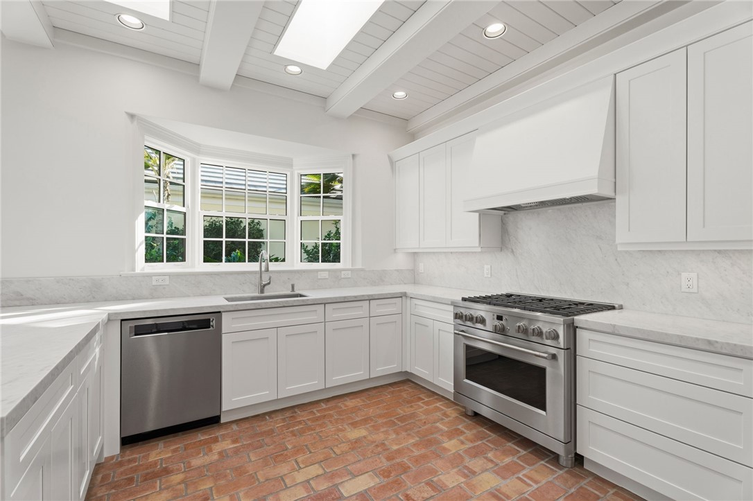 201 Sundial Court Vero Beach, FL 32963 - Photo 12 of 35 a kitchen with a stove sink and microwave
