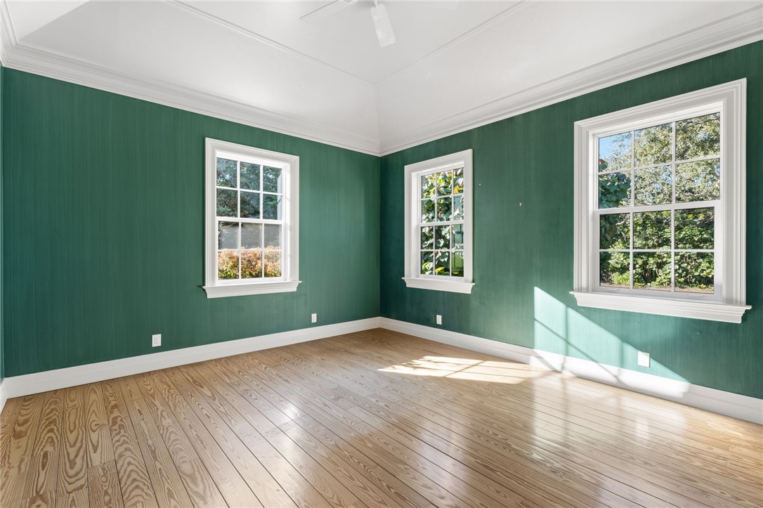 201 Sundial Court Vero Beach, FL 32963 - Photo 25 of 35 an empty room with wooden floor and windows