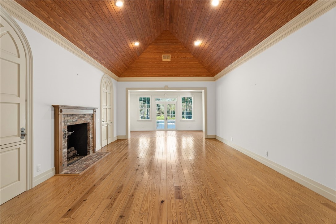 201 Sundial Court Vero Beach, FL 32963 - Photo 6 of 35 a view of an empty room with wooden floor and a window