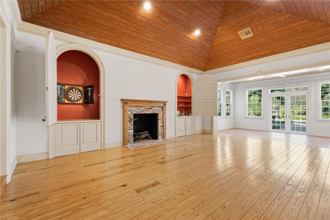201 Sundial Court Vero Beach, FL 32963 - Photo 7 of 35 a view of empty room with wooden floor and fireplace