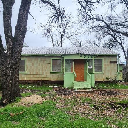 8916 Placer Road Redding, CA 96001 - Photo 1 of 1 a front view of a house with garden