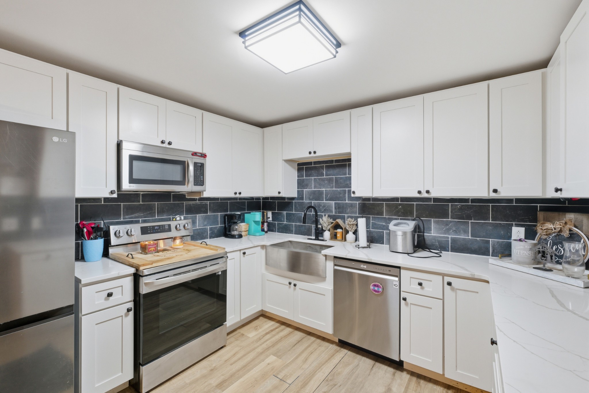 240 Myers Road Winchester, TN 37398 - Photo 13 of 38 a kitchen with a sink stove and white cabinets
