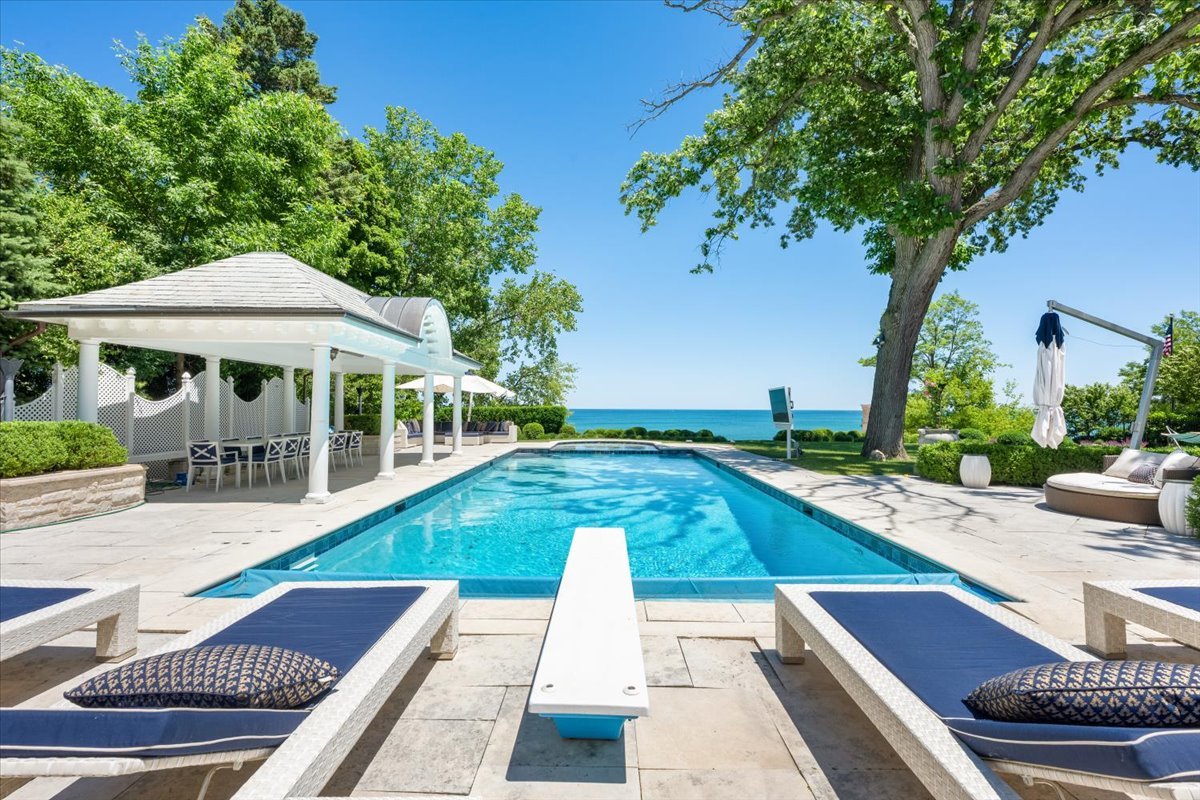 319 Sheridan Road Winnetka, IL 60093 - Photo 13 of 81 a view of swimming pool with lounge chair and dinning table under an umbrella