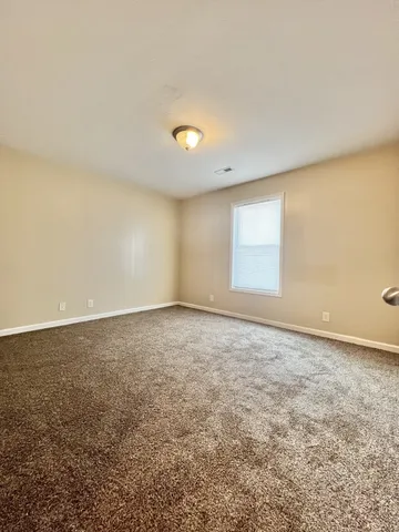 an empty room with a empty space and a window