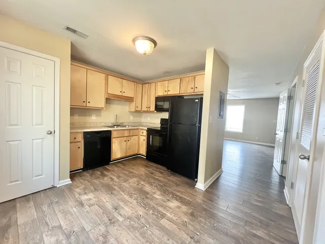 a kitchen with stainless steel appliances granite countertop a refrigerator a sink and a stove