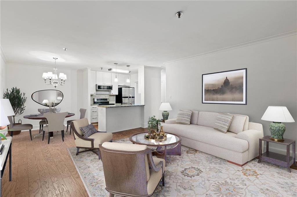 a living room with furniture a table and kitchen view