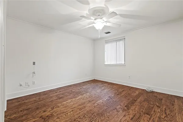 wooden floor in an empty room with a window