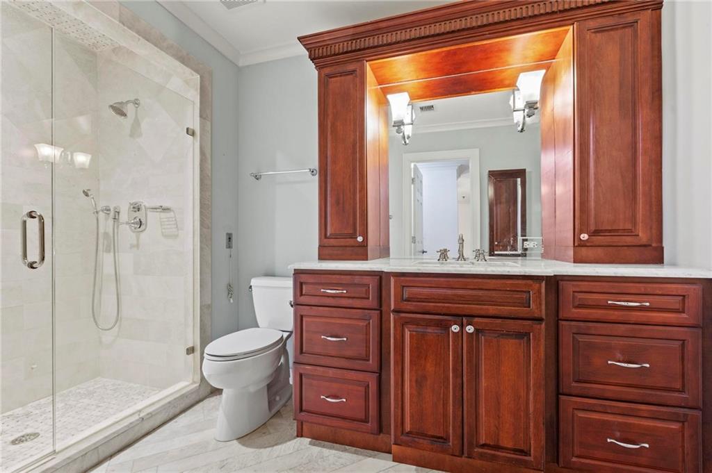 300 Johnson Ferry Road, Unit A110 Atlanta, GA 30328 - Photo 16 of 27 a bathroom with a granite countertop sink toilet a mirror and shower