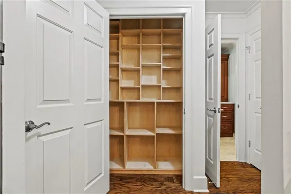 a view of walk in closet with empty racks