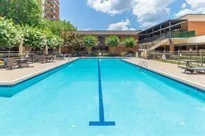 a view of a swimming pool with a patio and a yard