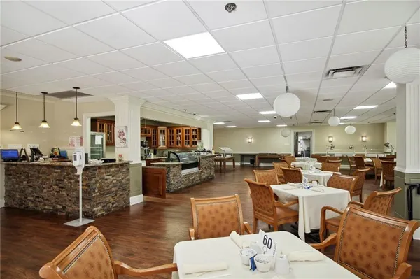 a view of a dining room with furniture a chandelier and wooden floor