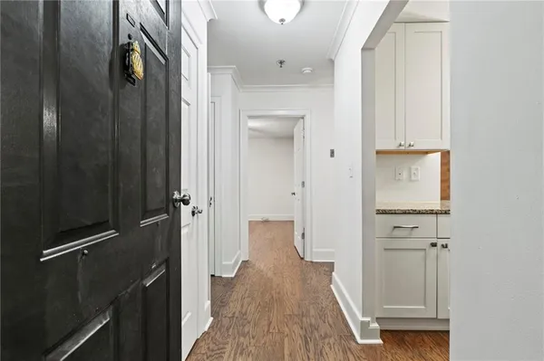 a view of a hallway with wooden floor
