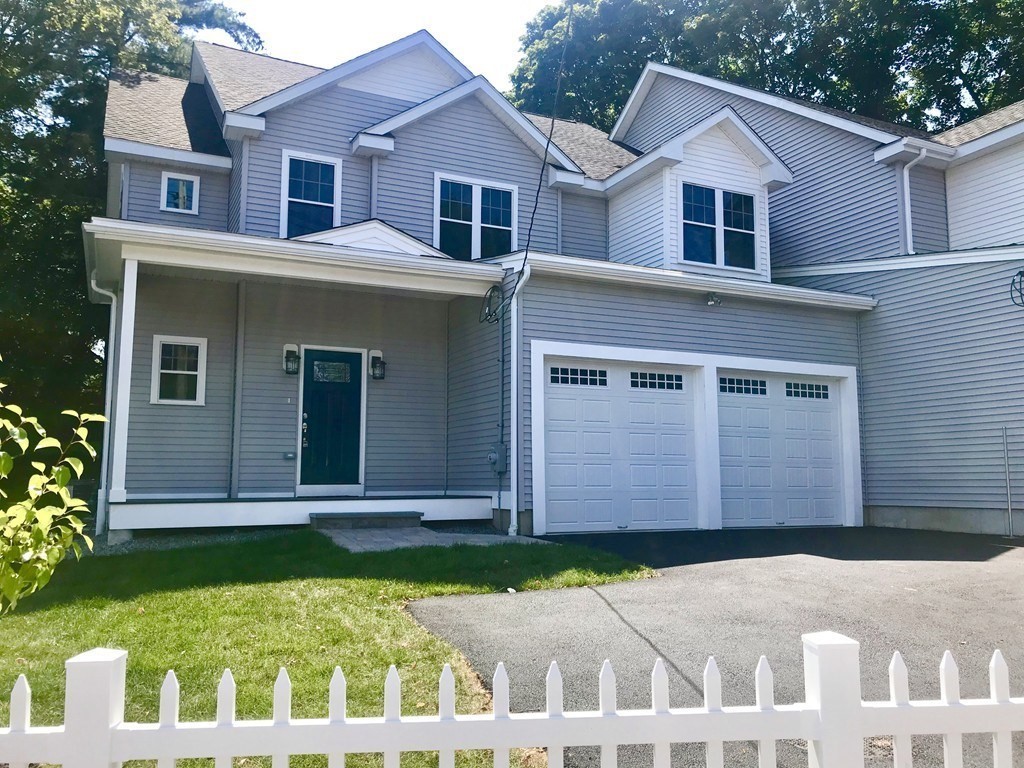 93 Calvary Street, Unit 2 Waltham, MA 02453 - Photo 1 of 33 a front view of a house with a yard