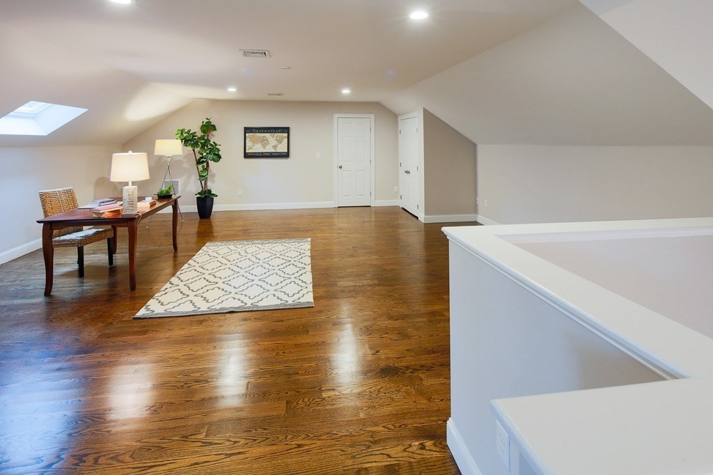 93 Calvary Street, Unit 2 Waltham, MA 02453 - Photo 11 of 33 a living room with hard wood floors and a table