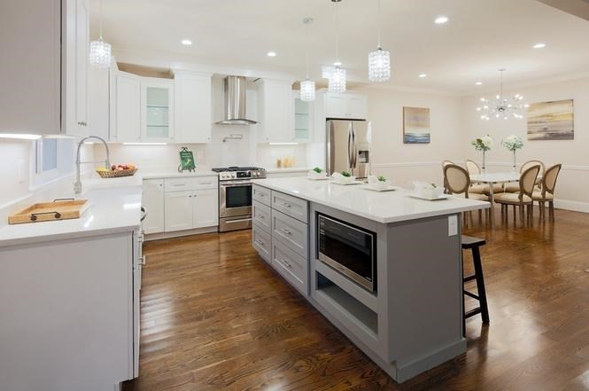 93 Calvary Street, Unit 2 Waltham, MA 02453 - Photo 12 of 33 a kitchen with kitchen island a stove a table and chairs