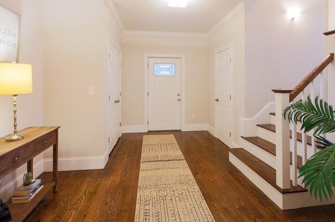 93 Calvary Street, Unit 2 Waltham, MA 02453 - Photo 19 of 33 a view of a hallway with wooden floor and staircase