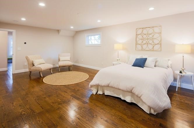 93 Calvary Street, Unit 2 Waltham, MA 02453 - Photo 22 of 33 a bedroom with a bed and wooden floor