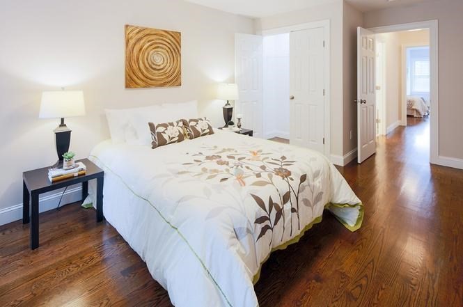 93 Calvary Street, Unit 2 Waltham, MA 02453 - Photo 26 of 33 a bedroom with bed and wooden floor